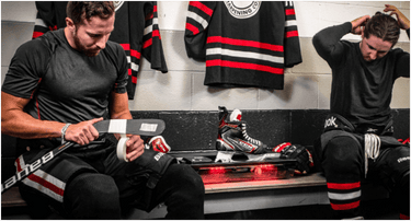 Taping a Hockey Stick in the Locker Room Next to the ES200 Sparx Sharpener